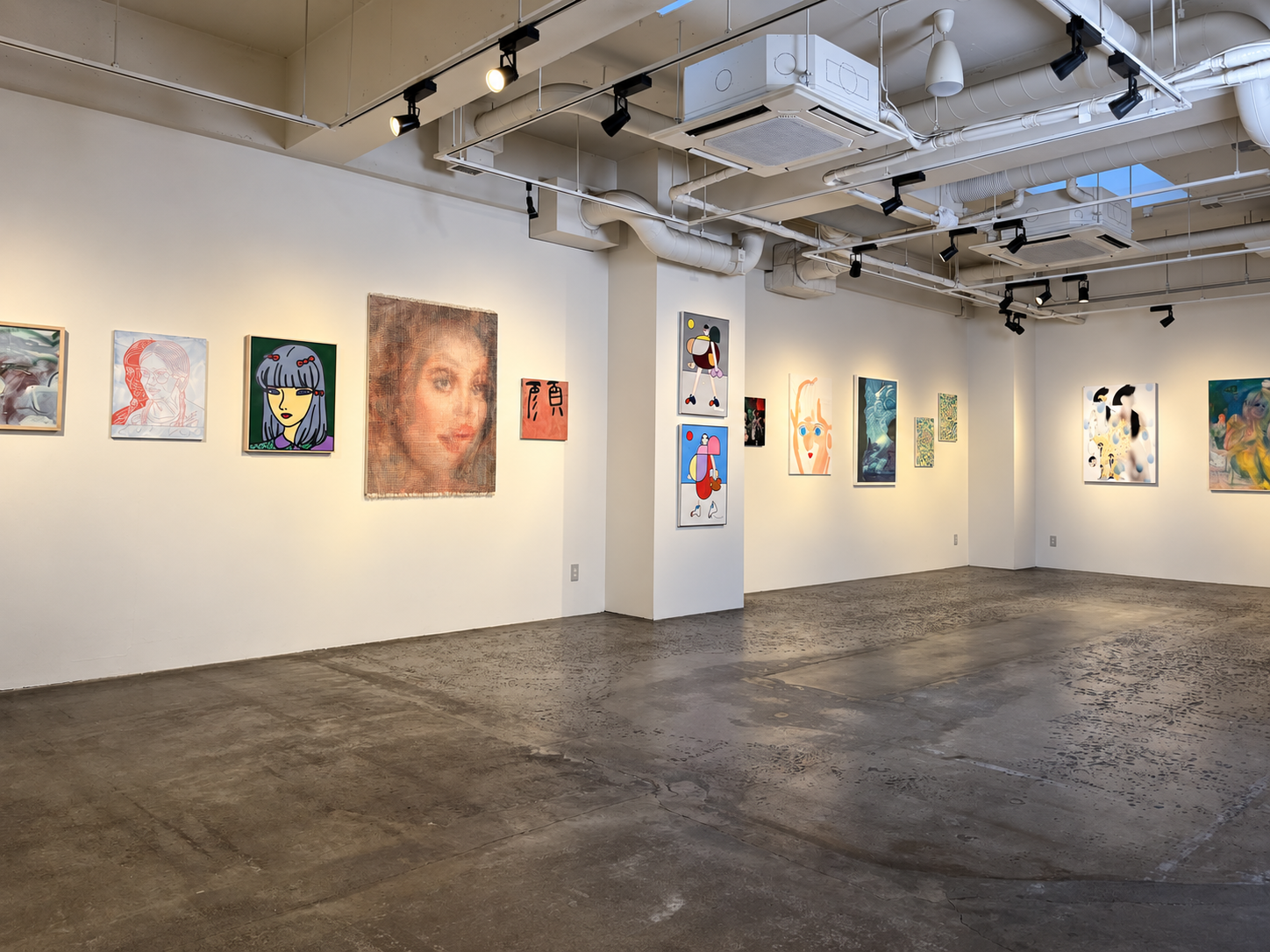 The exhibition space from the east wall to the south wall, with portraits and paintings arranged across walls and columns