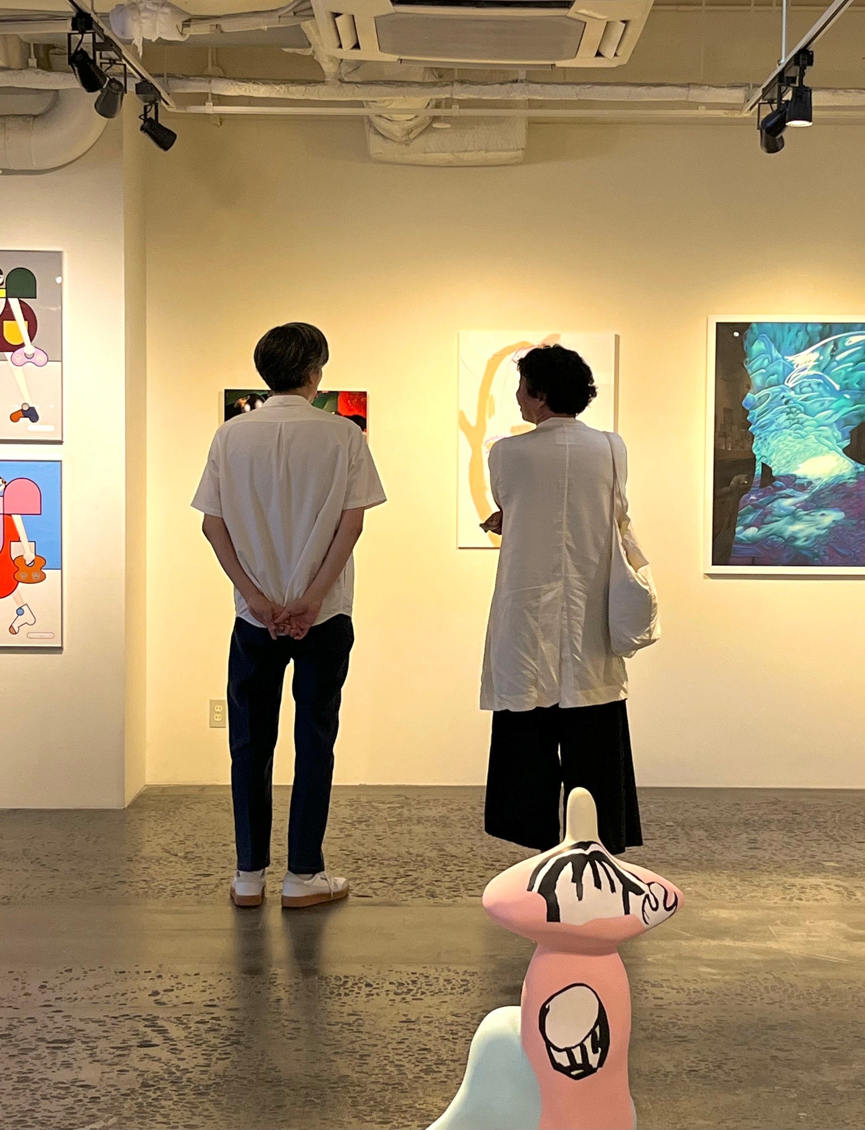 Kenichiro Mizuno and Atsushi Takeuchi in front of the exhibited works during the SAVVY interview